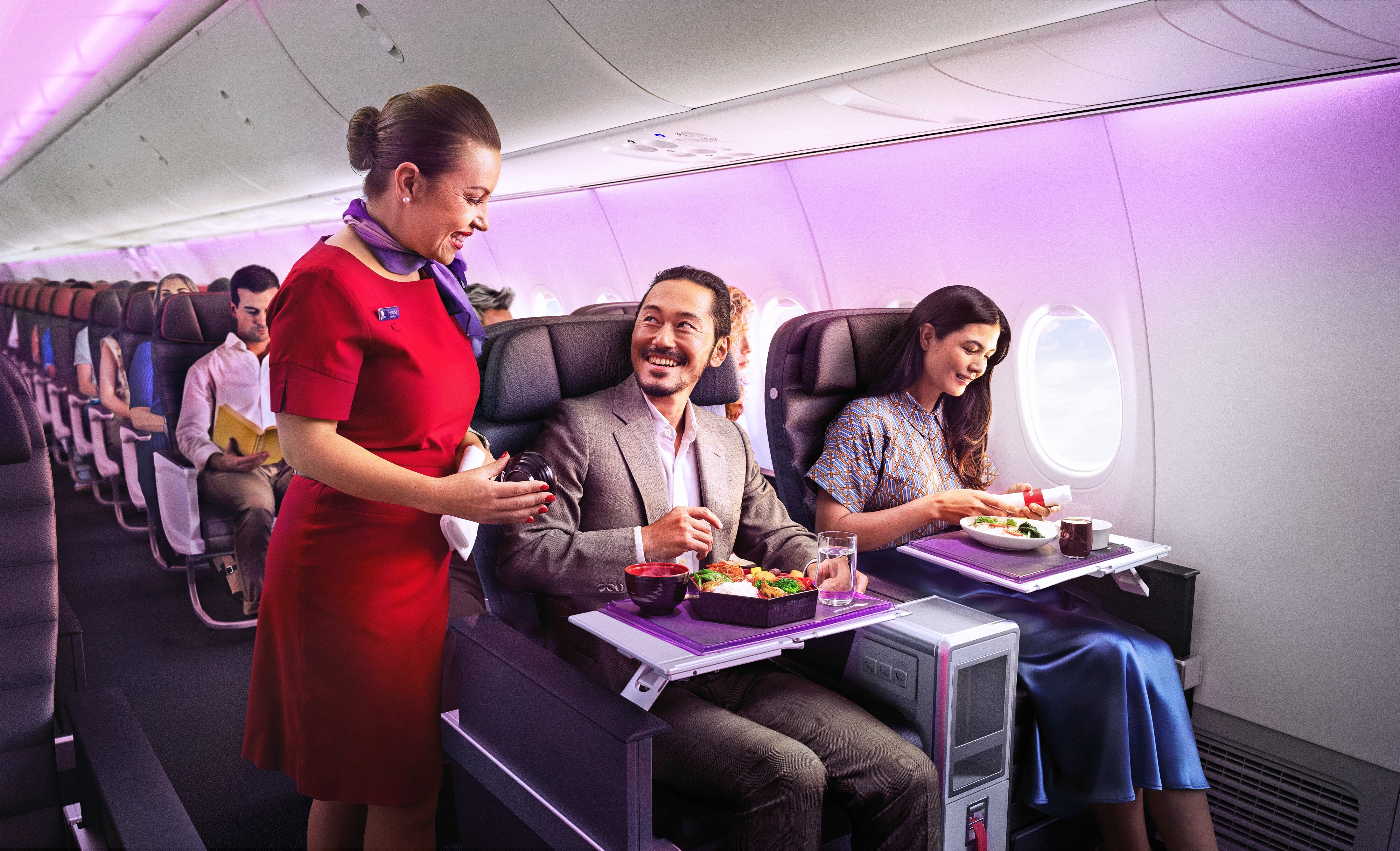 Image of flight attendant helping passengers on a Virgin Australia flight